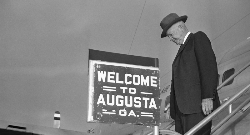 President Eisenhower passes a welcome sign as he arrives back in Augusta, Ga., April 18, 1960 after interrupting his vacation at nearby Augusta National Golf Club to fly to Washington to open the American League baseball season by tossing out the first ball. (AP) 