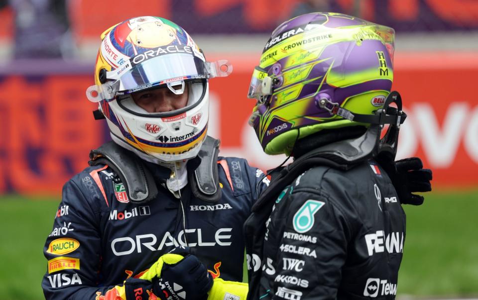 Red Bull Racing driver Sergio Perez (L) of Mexico and Mercedes driver Lewis Hamilton of Britain chat after the Sprint, ahead of the Formula One Chinese Grand Prix, in Shanghai, China, 20 April 2024