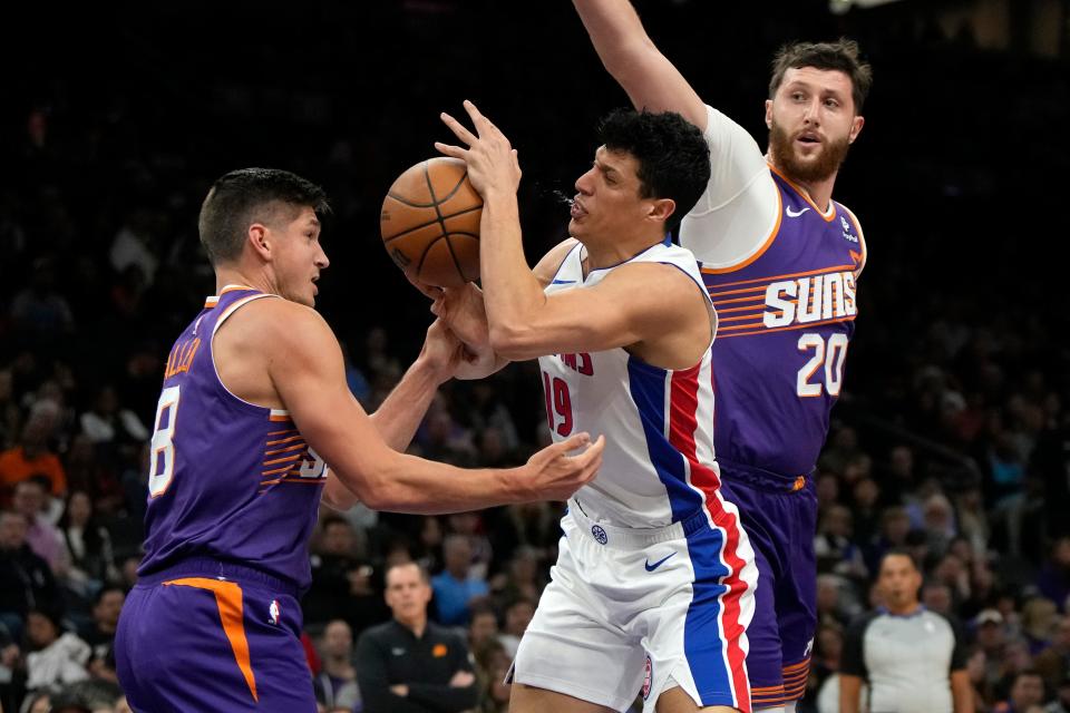 Pistons forward Simone Fontecchio drives between Suns guard Grayson Allen, left, and center Jusuf Nurkic during the first half on Wednesday, Feb. 14, 2024, in Phoenix.