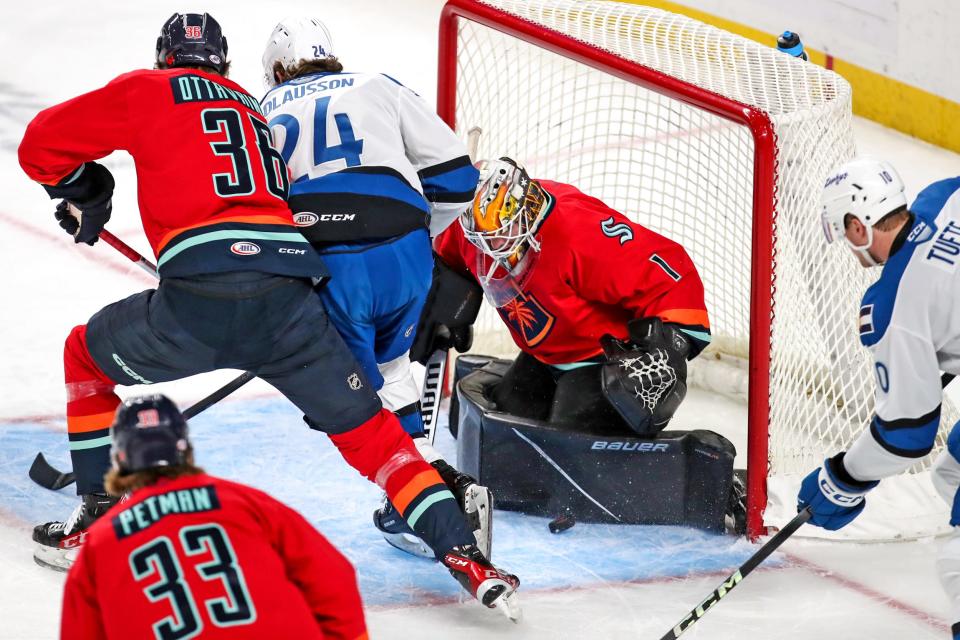 Coachella Valley Firebirds goaltender Cale Morris (1) makes a save during the game against the Colorado Eagles at Acrisure Arena in Palm Desert, Calif., on Sunday, Dec. 17, 2023.