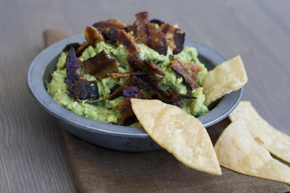 In this image taken on January 7, 2013, sweet heat bacon guacamole is shown served in a bowl in Concord, N.H. (AP Photo/Matthew Mead)