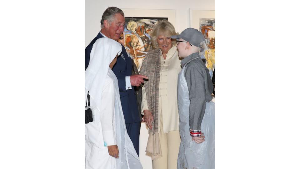 King Charles and Queen Camilla talking to children in Qatar