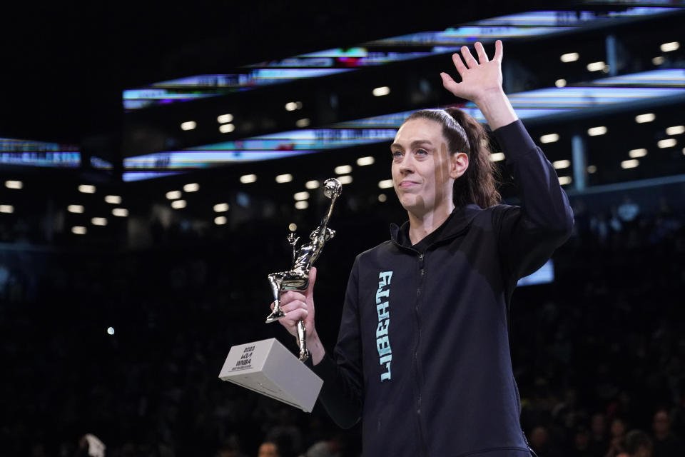 New York Liberty forward Breanna Stewart waves to fans while holding the MVP trophy before Game 2 of a WNBA basketball playoffs semifinal between the Liberty and the Connecticut Sun, Tuesday, Sept. 26, 2023, in New York. (AP Photo/Mary Altaffer)