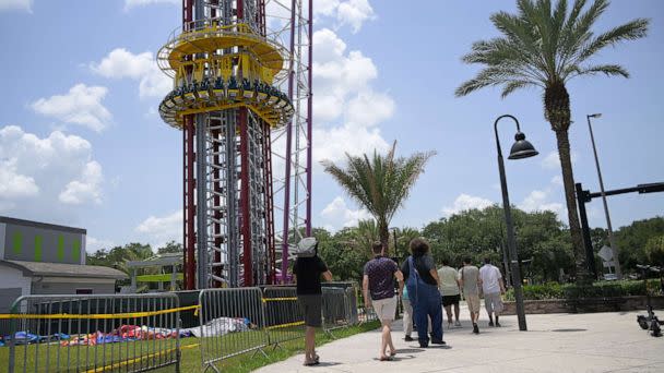 PHOTO: People walk past the Orlando Free Fall ride at the ICON Park entertainment complex, where Tyre Sampson fell to his death while on the ride in Orlando, Fla. June 15, 2022. (Phelan M. Ebenhack/AP, FILE)