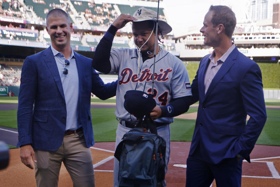 Former Minnesota Twins players Joe Mauer, left, and Justin Morneau, right, present retiring Detroit Tigers designated hitter Miguel Cabrera with some fishing gear to honor his career, before a baseball game Tuesday, Aug. 15, 2023, in Minneapolis. (AP Photo/Bruce Kluckhohn)