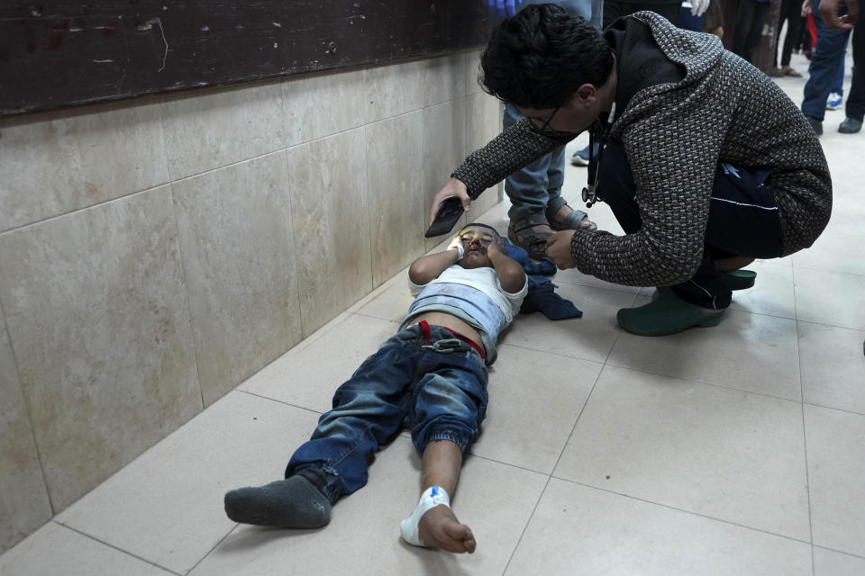 Palestinians wounded in the Israeli bombardment of the Gaza Strip are brought to the hospital in Deir al Balah, Gaza Strip, on Tuesday, Dec. 19, 2023. (AP Photo/Adel Hana)