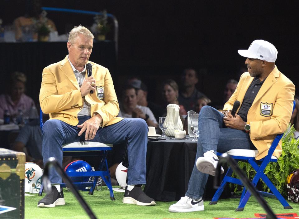 New Hall of Famers Joe Klecko (left) and Rondé Barber talk during the Enshrinees’ Roundtable on Sunday.