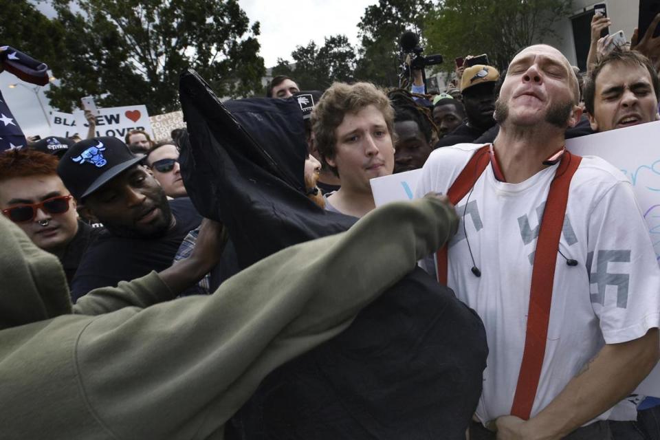 Furniss's head is rocked back after receiving the blow at the far-right rally in Florida (AP)