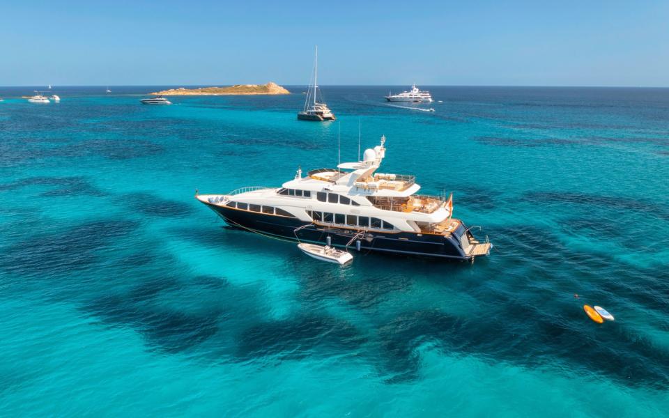 Aerial view of luxury yacht in blue sea on a sunny day in summer