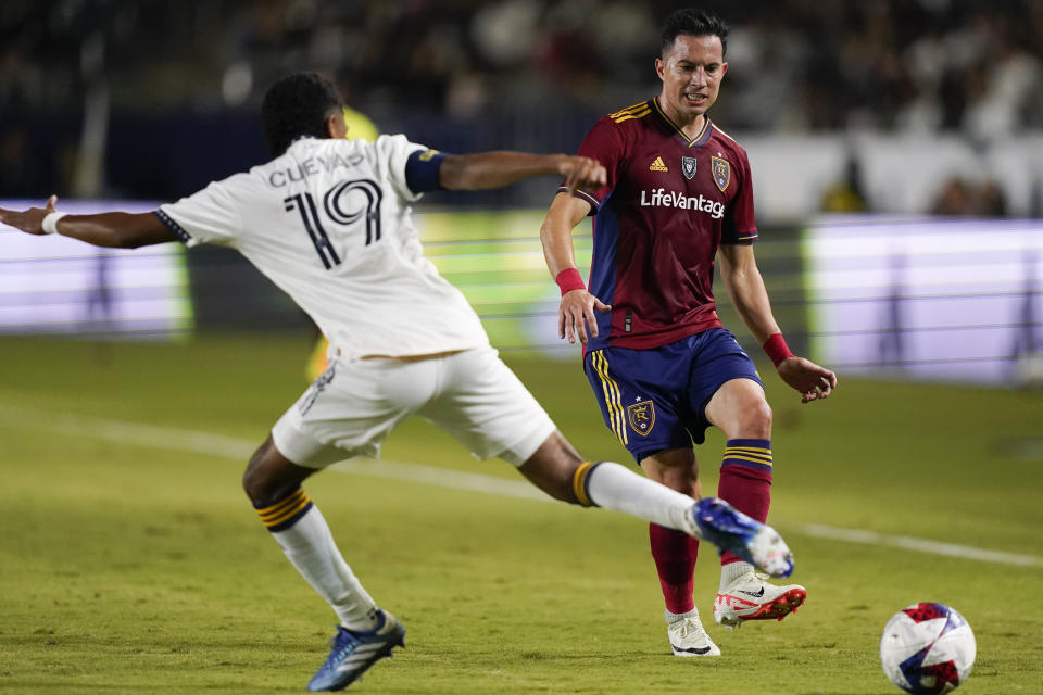 Real Salt Lake defender Bryan Oviedo, right, passes the ball past LA Galaxy defender Mauricio Cuevas during the first half of an MLS soccer match Saturday, Oct. 14, 2023, in Carson, Calif. (AP Photo/Ryan Sun)