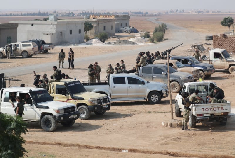 Turkey-backed Syrian rebel fighters gather near the border town of Tal Abyad