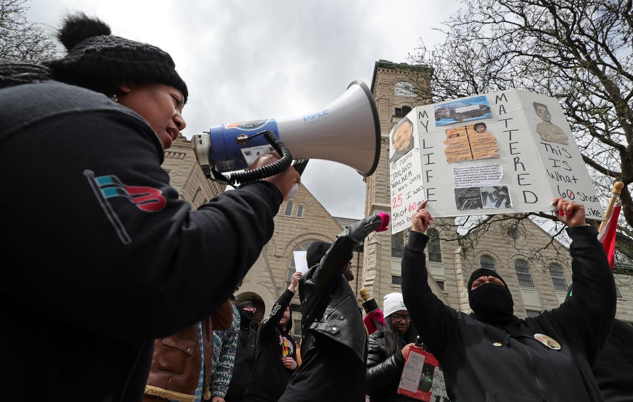 Protesters make their voices heard Tuesday during a march from First Congregational Church of Akron to the John F. Seiberling Federal Building in Akron.