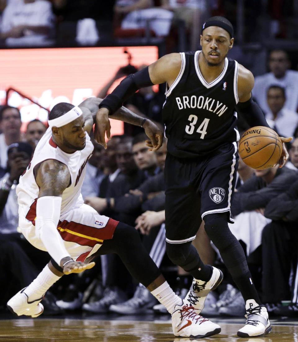 Brooklyn Nets' Paul Pierce (34) is fouled by Miami Heat's LeBron James, left, in the first half of Game 1 in an NBA Eastern Conference semifinal basketball series, Tuesday, May 6, 2014, in Miami. (AP Photo/Lynne Sladky)