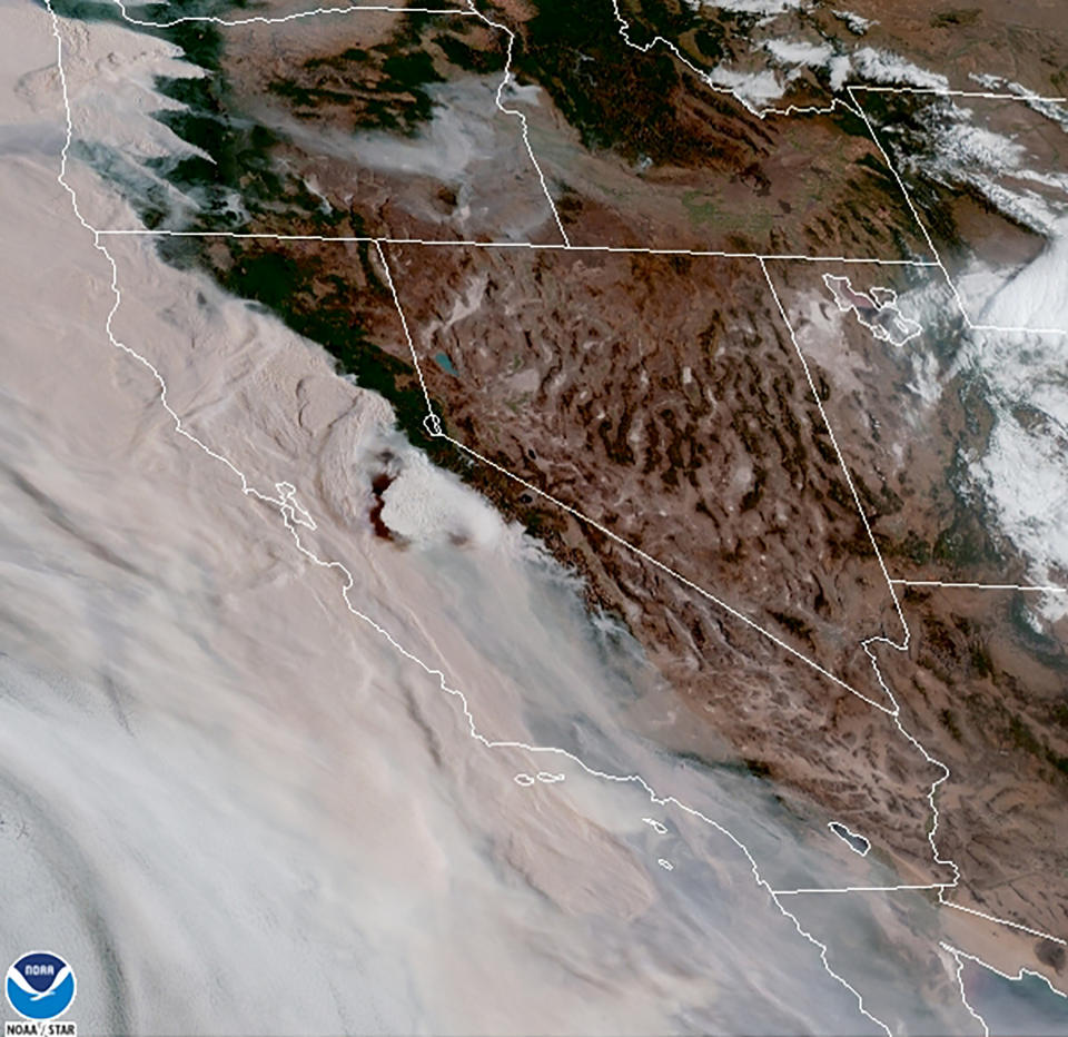 This satellite image provided by the National Oceanic and Atmospheric Administration (NOAA) at 15:31 UTC (7:31 a.m. PDT) on Wednesday, Sept. 9, 2020, shows brown smoke from wildfires blowing westward, from California's Sierra Nevada to the Coast Ranges, at center to left, and from Oregon at top left, affecting air quality throughout the West. Smoke mixes with clouds and overcast along the coast. Millions of acres of wildland and many homes and other structures have been lost to the flames. (NOAA via AP)