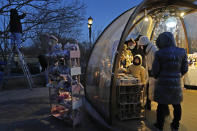 Shoppers return to a mall with shops re-opening for business as restrictions are eased in Beijing, Saturday, Dec. 3, 2022. Chinese authorities on Saturday announced a further easing of COVID-19 curbs with major cities such as Shenzhen and Beijing no longer requiring negative tests to take public transport. (AP Photo/Ng Han Guan)