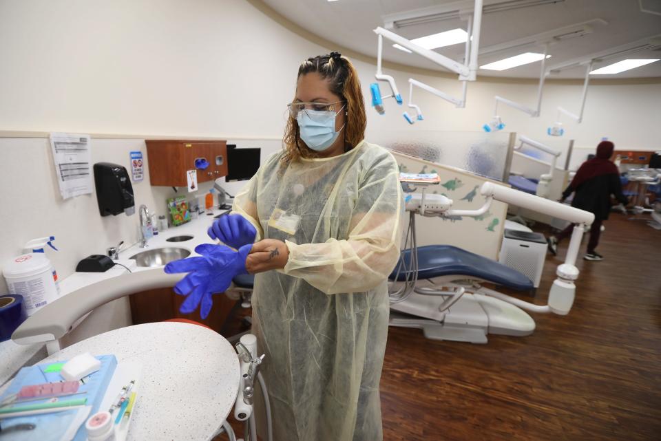 Carmen Franco, a dental assistant at the pediatric dentistry at Eastman Dental, prepares for a tooth extraction.