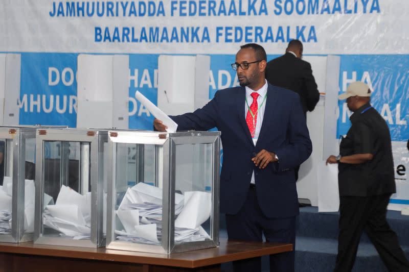 A member of the Somali parliament casts a ballot during the first round of the Somali presidential elections, in Mogadishu