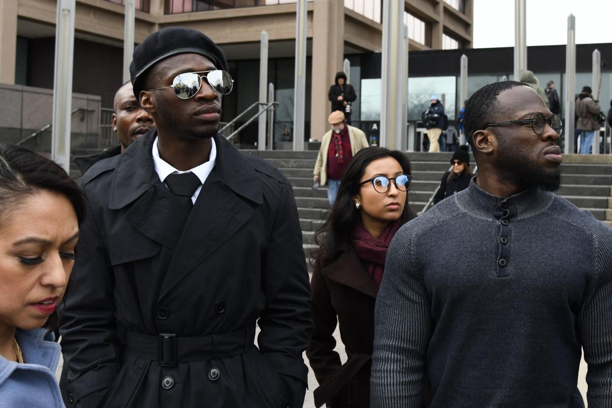 Attorney Gloria Schmidt, left, stands with her clients, brothers Olabinjo Osundairo, right, and Abimbola Osundairo, as they leave the Leighton Criminal Courthouse in Chicago on Monday, Feb. 24, 2020, where actor Jussie Smollett made an appearance on a new set of charges alleging that he lied to police about being targeted in a racist and homophobic attack in downtown Chicago early last year.