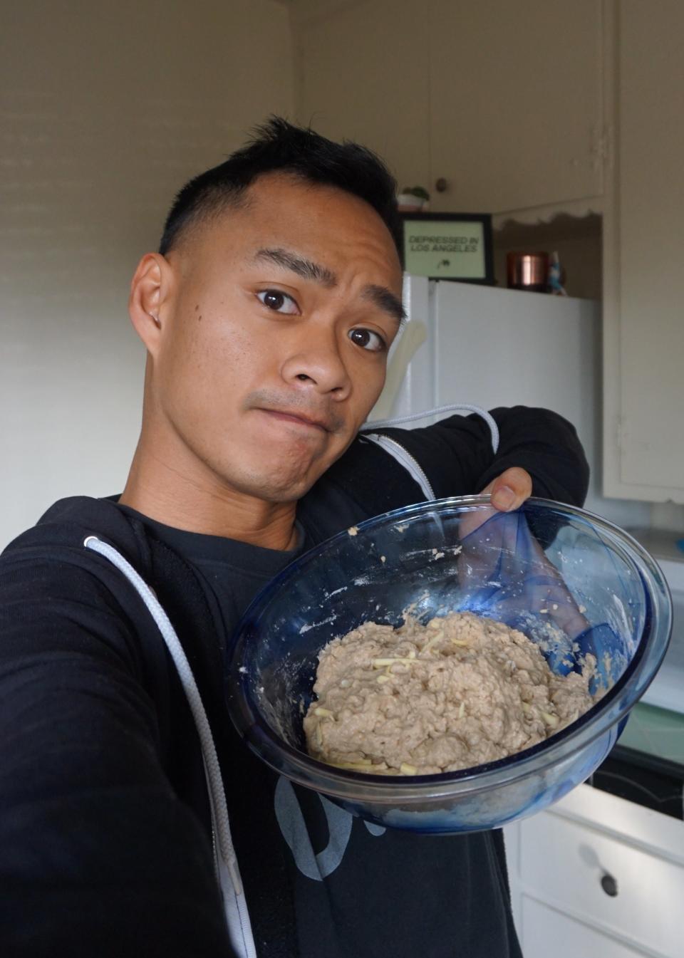 Author holding up the beer bread mix in a large bowl