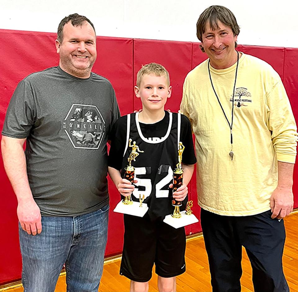 Sam Tirney is the 2022-23 recipient of the Kelley Lalley Memorial Award, presented to one Honesdale Biddy Basketball Association player each year for outstanding play and sportsmanship. Sam is shown here accepting his award from his Dad, Brian, and Jamie Rutherford.