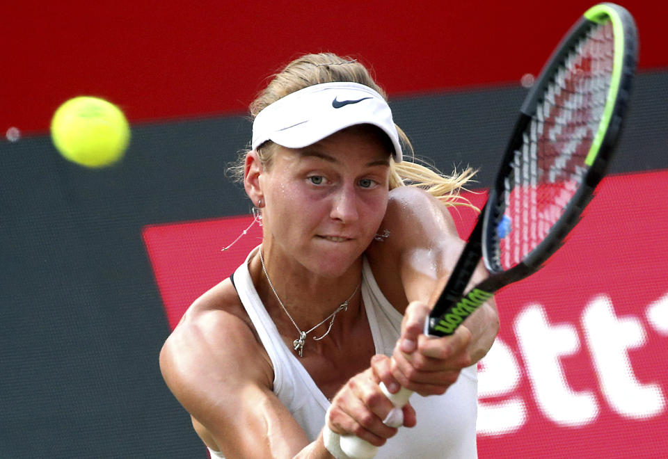 Russia's Ludmilla Samsonova plays a backhand during her ladies singles final tennis match against Switzerland's Belinda Bencic at the German Open at the Steffi Graf Stadium in Berlin, Sunday, June 20, 2021. (Wolfgang Kumm/dpa via AP)