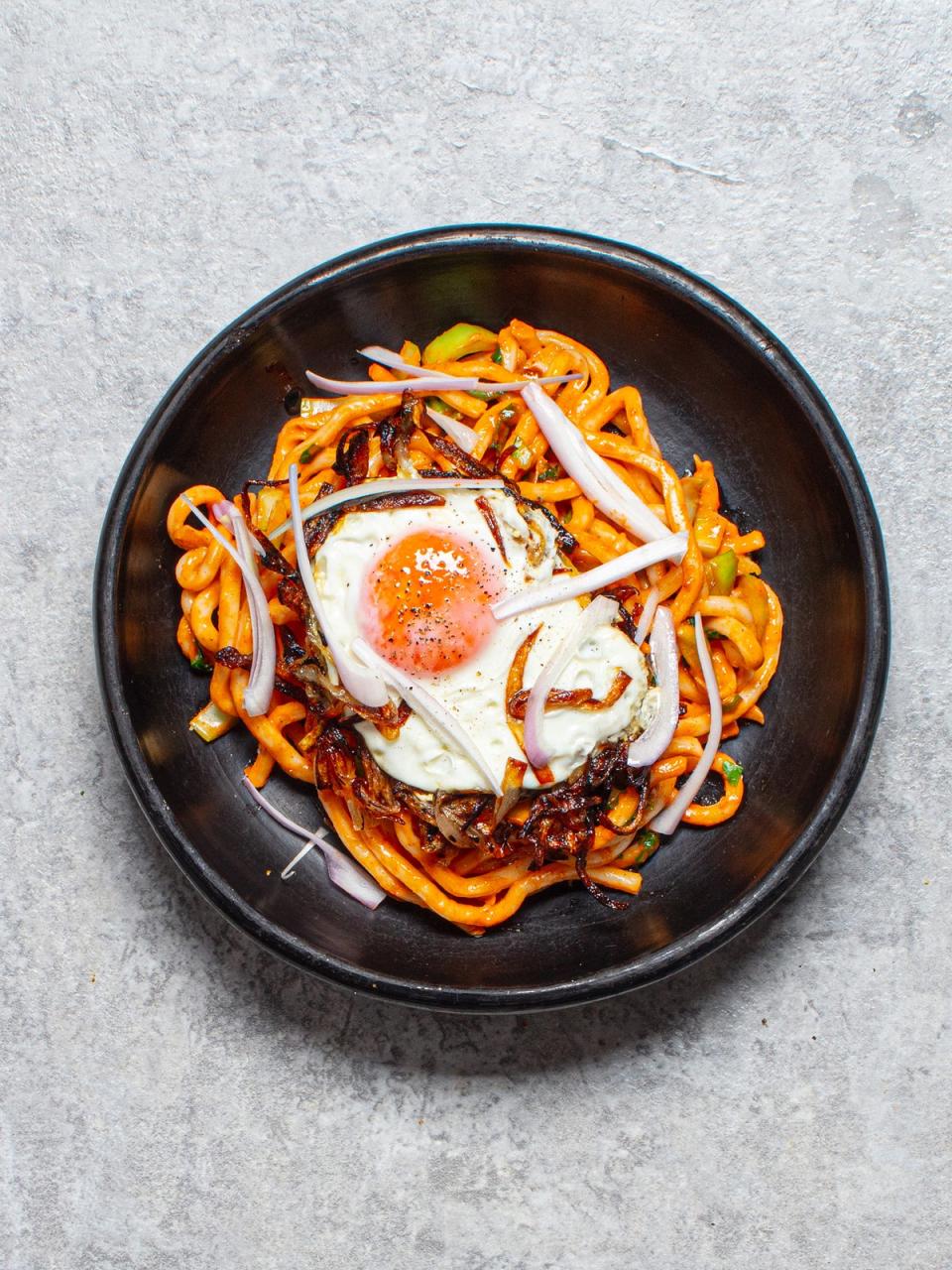 A fried egg with crispy, onion-y edges is the perfect complement to these spicy noodles (Sorted Food)