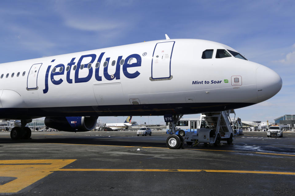 FILE - A JetBlue airplane is shown at John F. Kennedy International Airport in New York, March 16, 2017. A federal judge is siding with the Biden administration and blocking JetBlue Airways from buying Spirit Airlines, saying the $3.8 billion deal would reduce competition. The Justice Department sued to block the merger, saying it would drive up fares by eliminating Spirit, the nation’s biggest low-cost airline. (AP Photo/Seth Wenig, File)