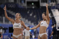 Anastasija Kravcenoka, right, of Latvia, and teammate Tina Graudina celebrate winning a women's beach volleyball quarterfinal match against Canada at the 2020 Summer Olympics, Tuesday, Aug. 3, 2021, in Tokyo, Japan.(AP Photo/Felipe Dana)