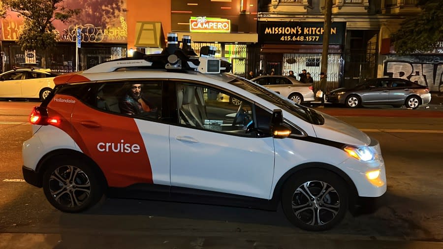 A Cruise driverless taxi picks up a passenger in San Francisco’s Mission District on Feb. 15, 2023. (AP Photo/Terry Chea)