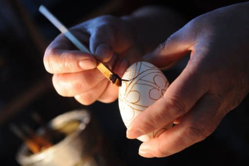 Romanian Ioana Matei adorns eggs using beeswax and red dye in Niculesti village on April 13. When Ioana Matei learned to decorate eggs with her grandmother for Orthodox Easter using beeswax and red dye, she never imagined her creations would seduce people beyond Romania's borders