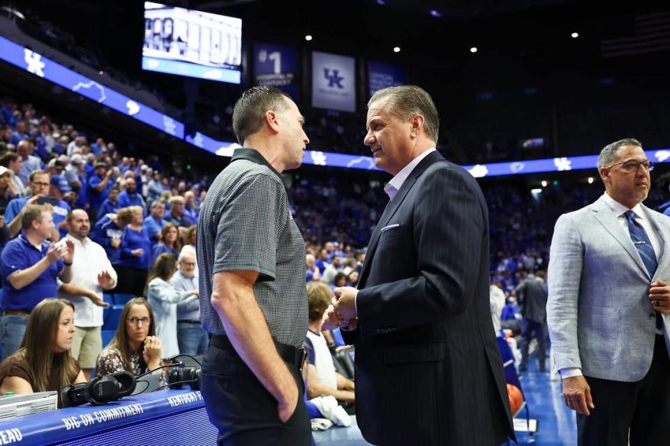 Kentucky men’s basketball coach John Calipari, right, speaks with New Mexico State coach Jason Hooten prior to the 2023-24 season-opening game at Rupp Arena.