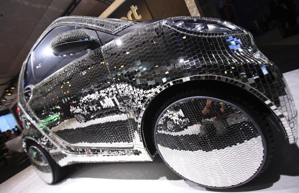 A “disco-ball” mirror covered Electric Drive Smart Car is seen on display at the New York International Auto Show in New York City April 20, 2011. REUTERS/Mike Segar