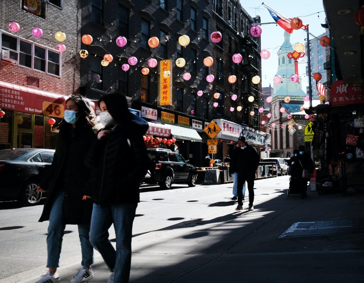 <span class="caption">Asian Americans have been targeted with hate crimes during the pandemic.</span> <span class="attribution"><a class="link " href="https://www.gettyimages.com/detail/news-photo/people-walk-through-the-streets-of-chinatown-on-march-02-news-photo/1304970747" rel="nofollow noopener" target="_blank" data-ylk="slk:Spencer Platt/Getty Images;elm:context_link;itc:0;sec:content-canvas">Spencer Platt/Getty Images</a></span>