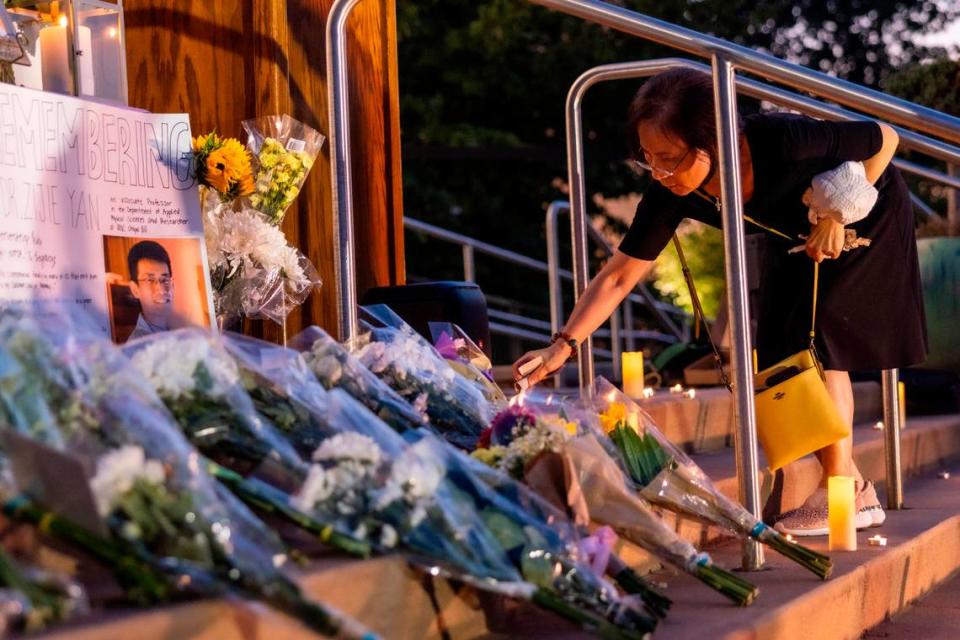 Candles are lit and flowers are laid on the steps of the Cary Arts Center in memory of UNC-Chapel Hill professor Zijie Yan during a candlelight vigil organized by the Chinese American Friends Association of North Carolina and and North Carolina Asian Americans Together on Tuesday evening, Sept. 5, 2023. Yan was shot and killed on campus on Monday, Aug. 28.