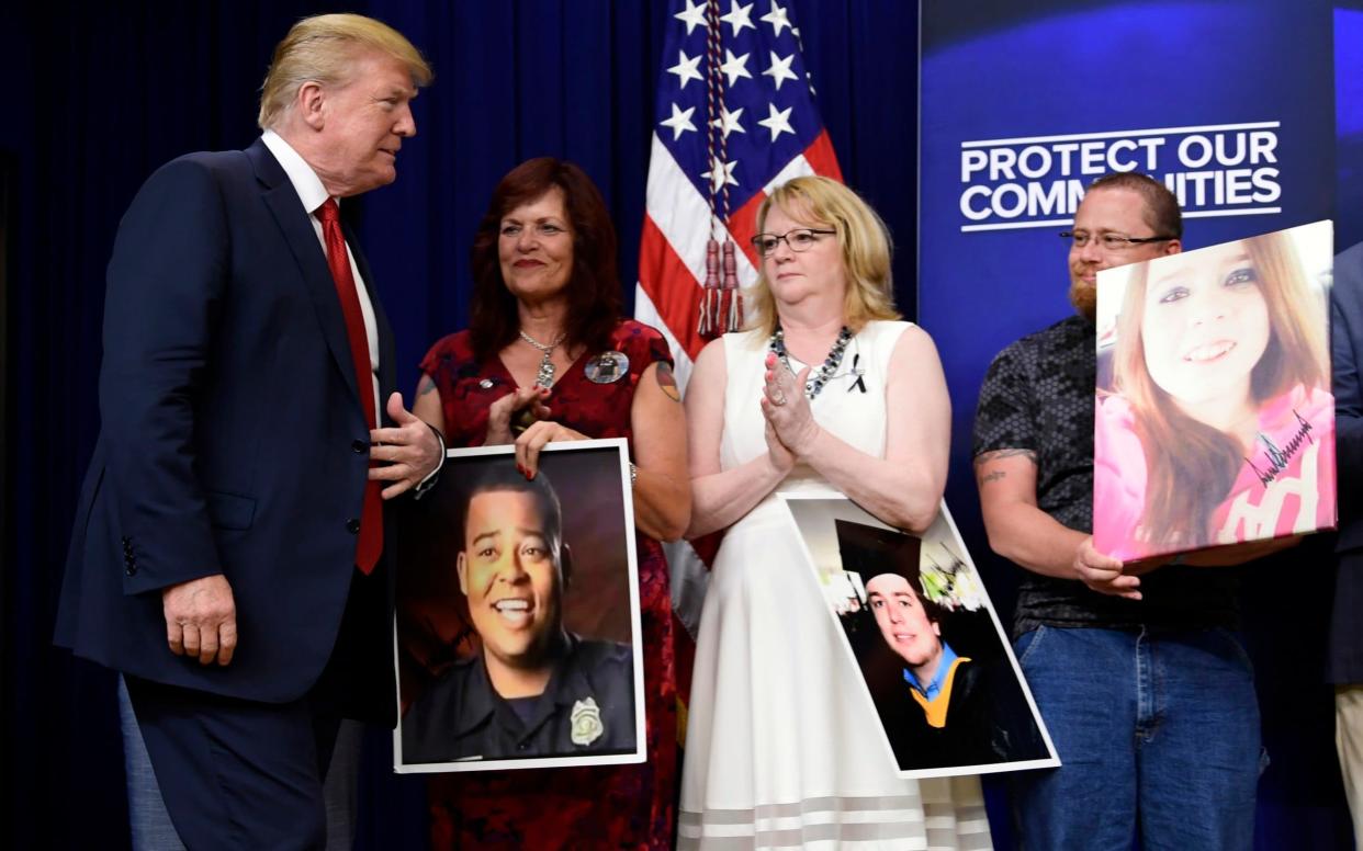 Donald Trump with relatives of people killed by undocumented immigrants - AP