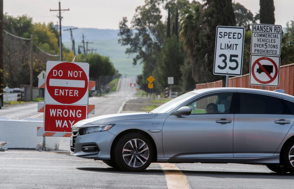 Signs and barriers marking lane closures put up by the San Joaquin County Department of Public Works block southbound traffic on Hansen Road at Von Sosten Road in rural Tracy. Area residents have complained about semitruck traffic on the road.