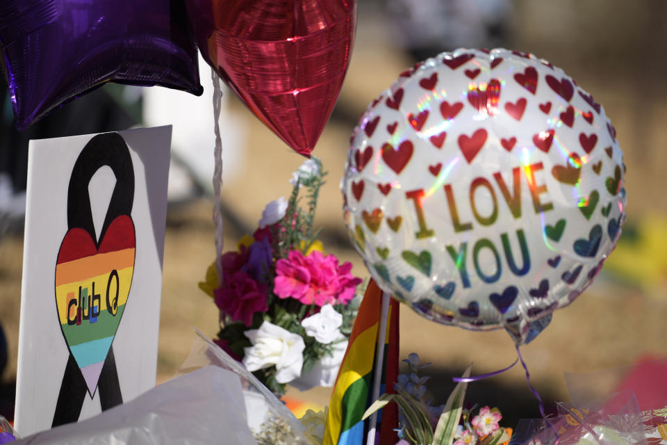 A Club Q sign stands amid items in a makeshift memorial to mark a weekend mass shooting at a nearby gay nightclub on Tuesday, Nov. 22, 2022, in Colorado Springs, Colo. Anderson Lee Aldrich opened fire at Club Q, in which five people were killed and others suffered gunshot wounds before patrons tackled and beat the suspect into submission. (AP Photo/David Zalubowski)