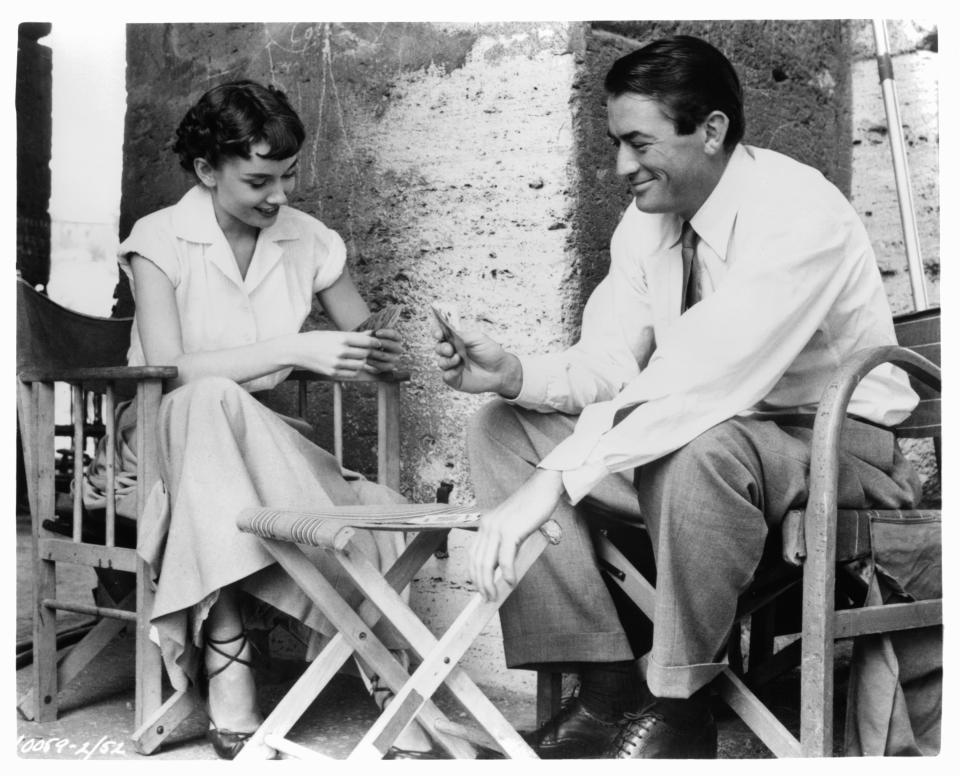 Audrey Hepburn plays cards with Gregory Peck in a scene from the film 'Roman Holiday', 1953. (Photo by Paramount/Getty Images)