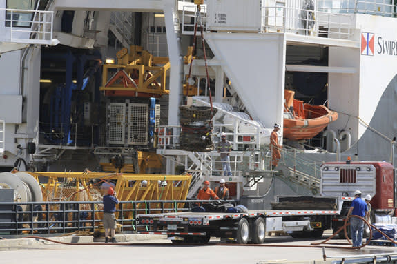 Workers unload parts for two Apollo Saturn V F-1 rocket engines recovered from the ocean floor by a private expedition led by Jeff Bezos, founder and CEO of Amazon.com and the commercial spaceflight company Blue Origin.