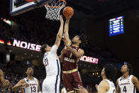 Boston College's T.J. Bickerstaff (1) fights for a basket against Virginia's Kadin Shedrick (21) during the first half of an NCAA college basketball game in Charlottesville, Va., Saturday, Jan. 28, 2023. (AP Photo/Mike Kropf)