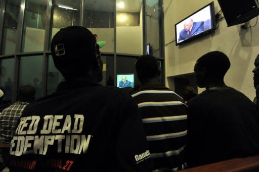 People watch a live broadcast of the trial of Liberian ex-leader Charles Taylor (on screen) inside the Special Court in Freetown April 26. Nations, rights groups and victims hailed a historic verdict after Taylor was convicted Thursday of aiding and abetting war crimes in Sierra Leone