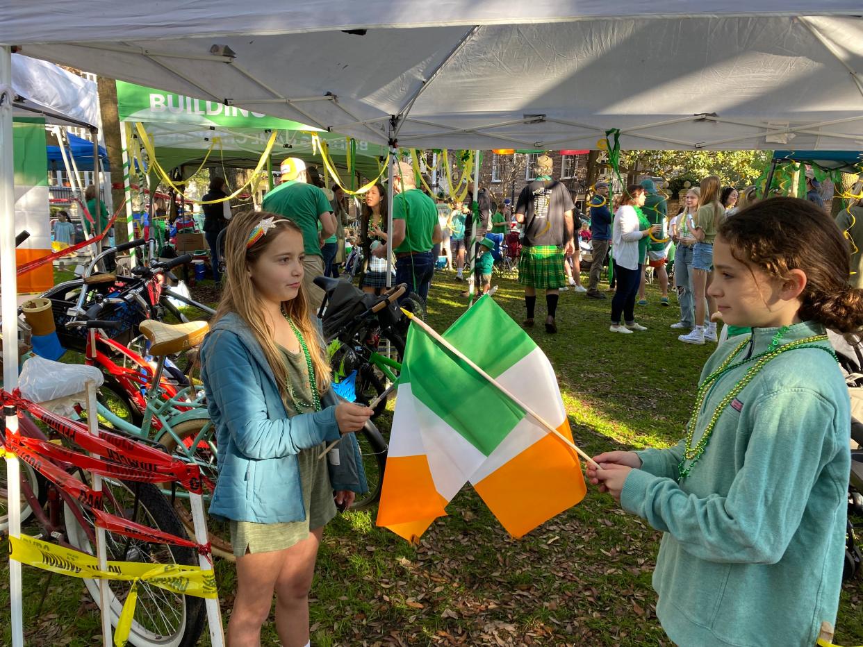 Ferris Key and Emma Jane Moody are enjoying their spring break by helping to guard a booth at the parade.