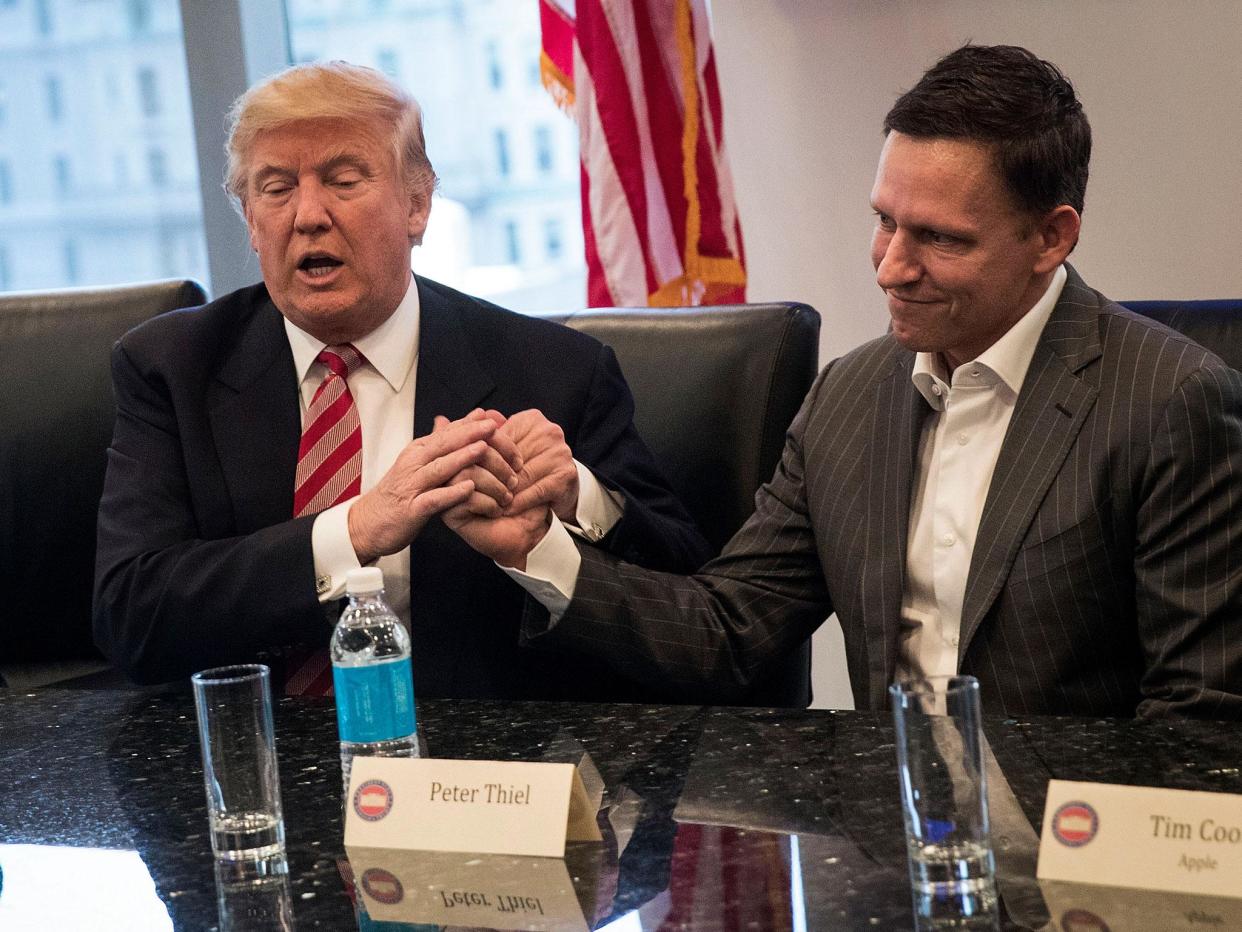 Donald Trump shakes hands with Peter Thiel during first major meeting with technology leaders: Drew Angerer/Getty Images