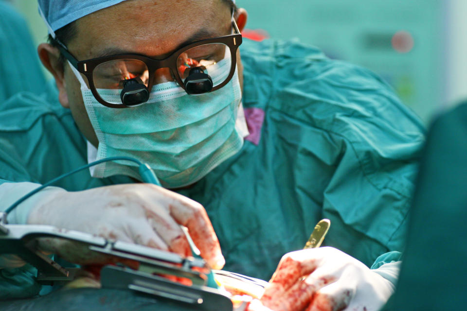 Cardiac surgeon performing surgery.