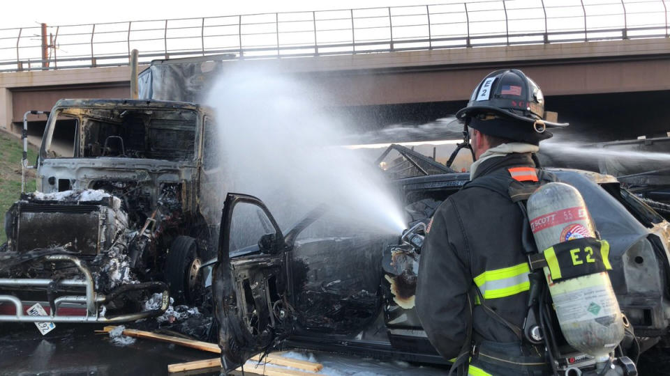 FILE - This Thursday, April 25, 2019 file photo provided by West Metro Fire Rescue shows a firefighter working the scene of a deadly pileup involving over two dozen vehicles near Denver. Colorado prosecutors, on Monday, May 20, want a judge to require a GPS monitor for Rogel Lazaro Aguilera-Mederos , the truck driver accused of causing the fiery pileup. (Ronda Scholting/West Metro Fire Rescue via AP,File)