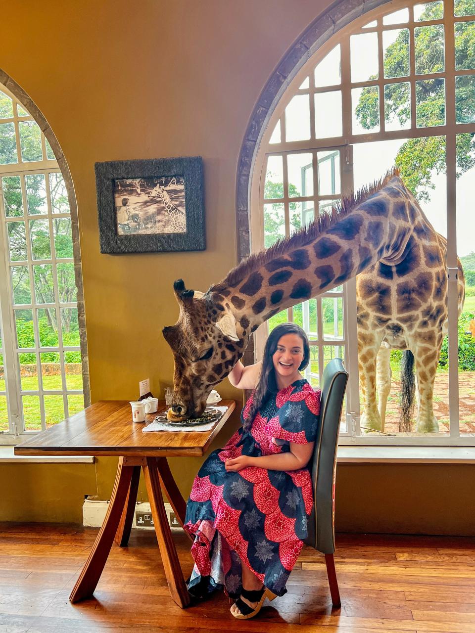 Author Jen Ruiz dining with a giraf