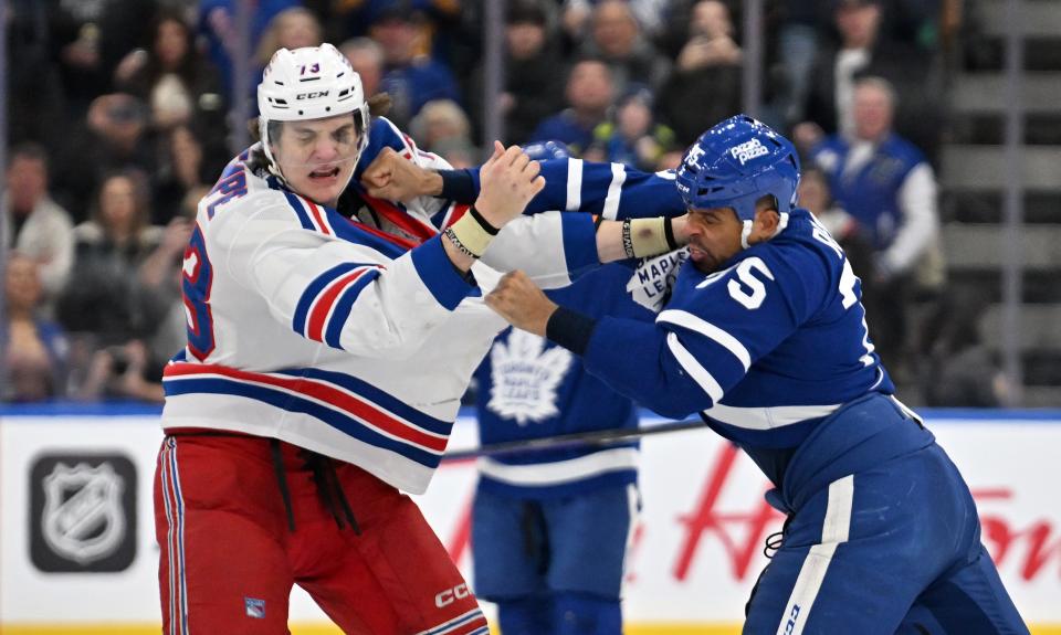 Mar 2, 2024; Toronto, Ontario, CAN; Toronto Maple Leafs forward Ryan Reaves (75) lands a punch as he fights with New York Rangers forward Matt Rempe (73) in the third period at Scotiabank Arena.