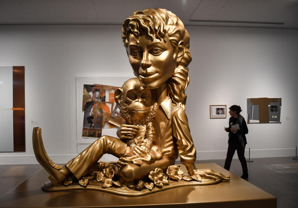 The sculpture 'Michael Jackson and Bubbles' from US artist Paul McCarthy' is presented at a preview of the exhibition 'Michael Jackson: On The Wall' at the Bundeskunsthalle museum in Bonn, Germany, Thursday, March 21, 2019. The exhibition around the controversial iconic pop idol is open until July 14. (AP Photo/Martin Meissner)