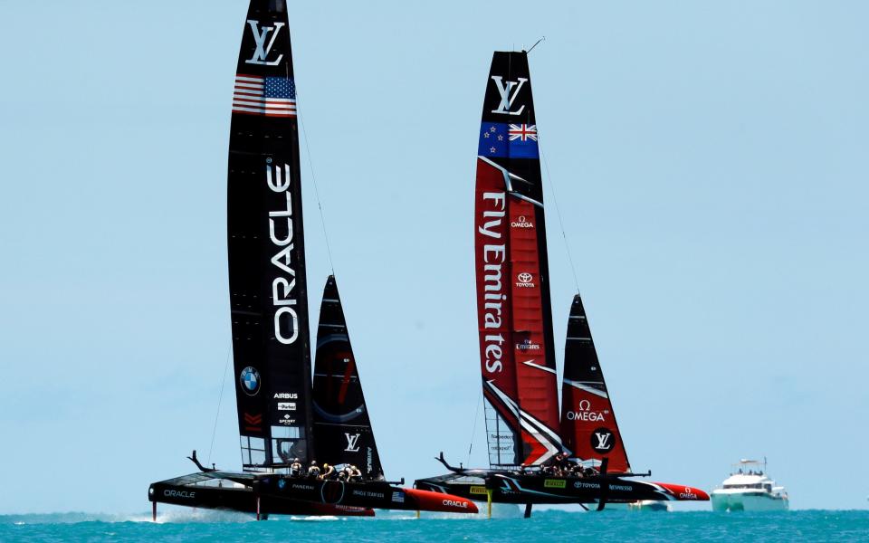 Emirates Team New Zealand, right, races Oracle Team USA - Credit: Gregory Bull/AP