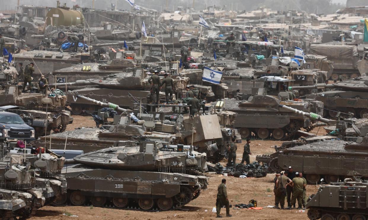 <span>Israeli soldiers stand next to military vehicles near the border with Gaza.</span><span>Photograph: Amir Cohen/Reuters</span>